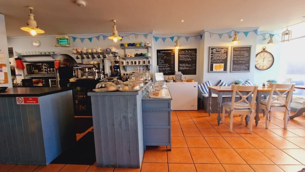 A wide angle that's showing Regency's kitchen and seating area. Venue hire in Teignmouth. Beautiful indoor café space.