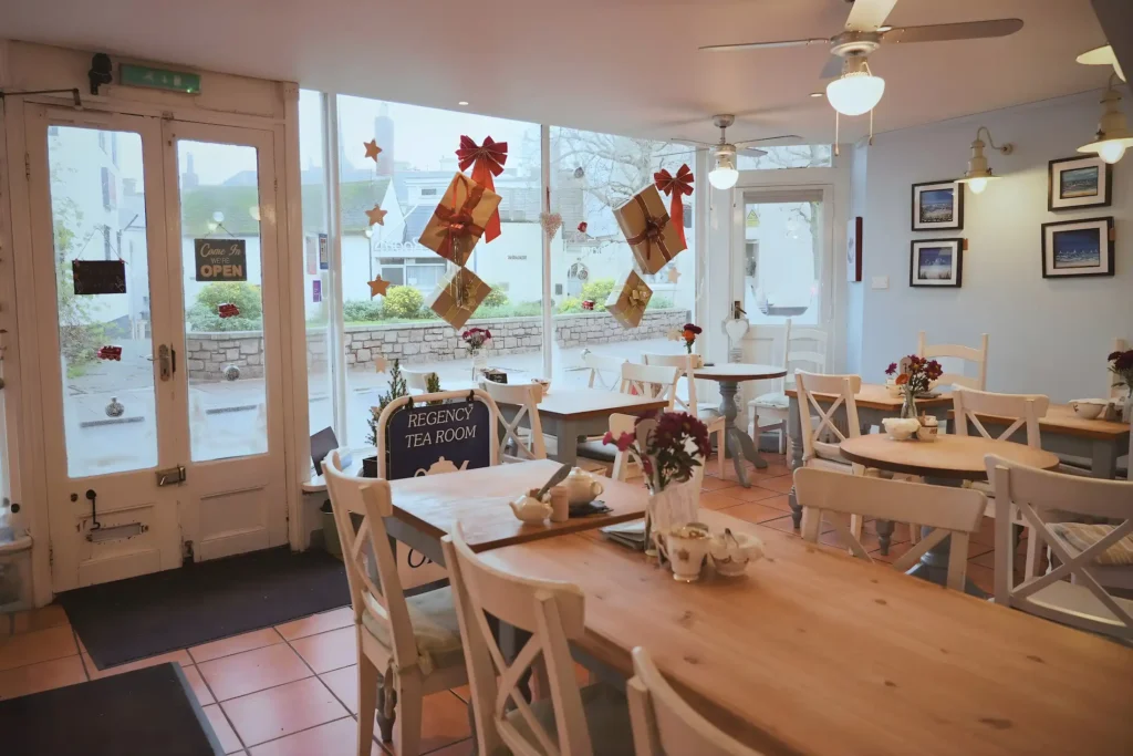 A wide image showing the seating, with windows that brighten up our café in Teignmouth.